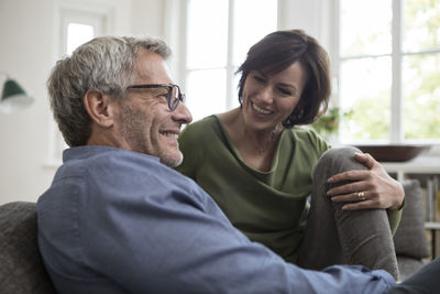 Smiling mature couple at home on the sofa