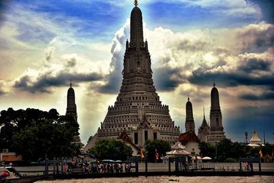 People at temple against sky in city