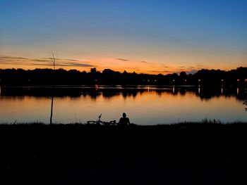 Scenic view of lake against sky during sunset