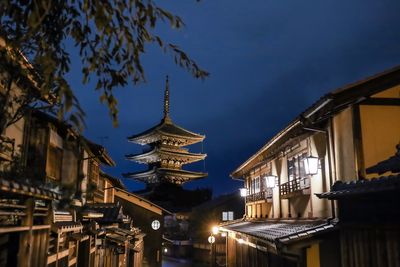 Low angle view of illuminated buildings against sky at night