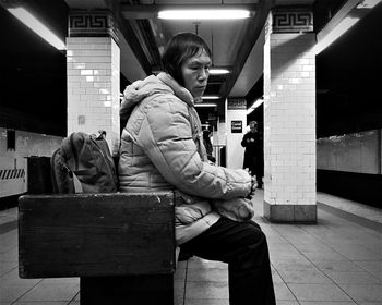 Full length of woman standing by railing