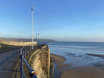 Scenic view of beach against blue sky