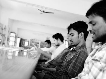 Young men sitting on floor