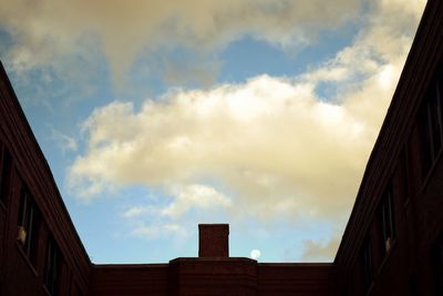 Low angle view of building against cloudy sky