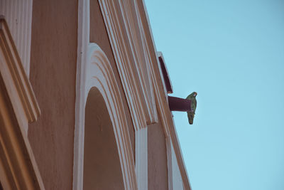 Low angle view of building against clear blue sky