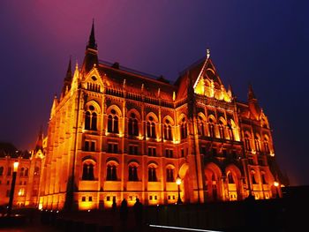 Low angle view of illuminated building at night