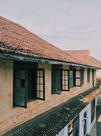 Exterior of old building in town against sky