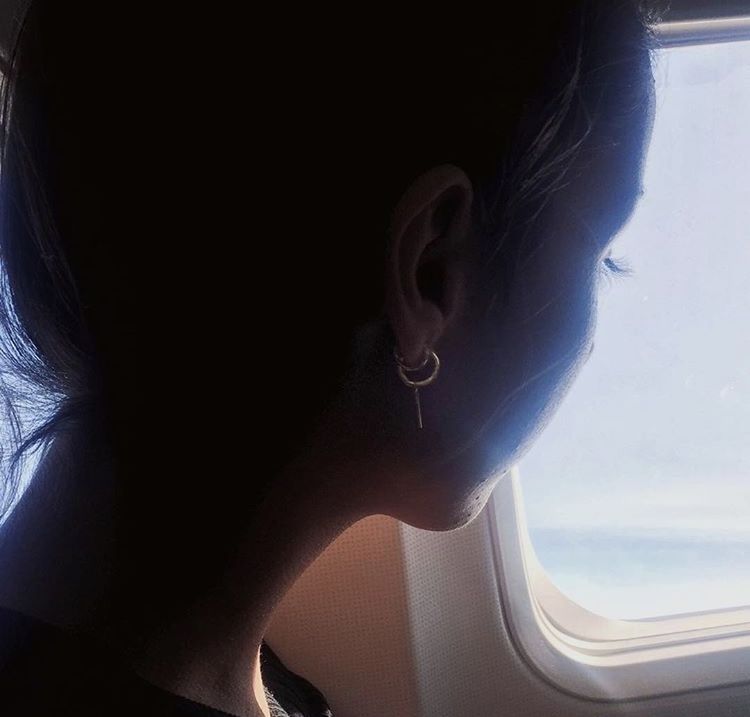 PORTRAIT OF WOMAN WITH AIRPLANE WINDOW