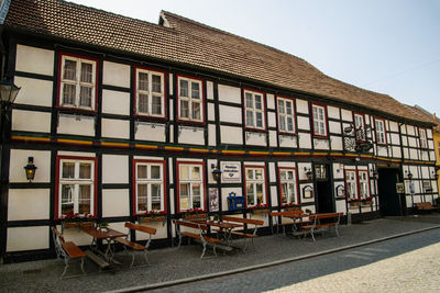 Building by street against sky in city