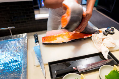 Midsection of person preparing food in kitchen