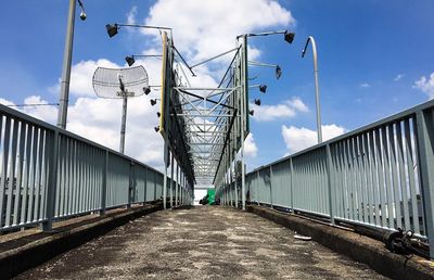 Low angle view of footbridge against sky