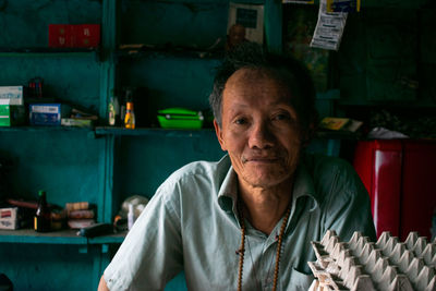 Portrait of smiling man sitting at home