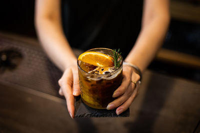 Midsection of man drinking glass