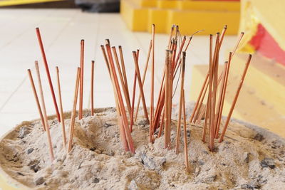 Close-up of burnt incense sticks at temple