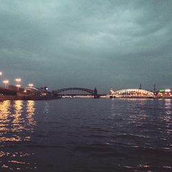 River in city against cloudy sky