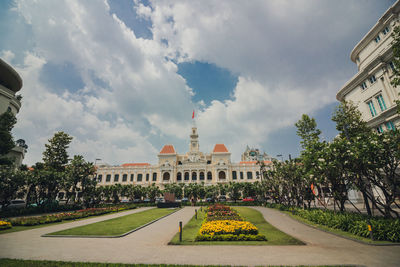 Buildings in city against cloudy sky