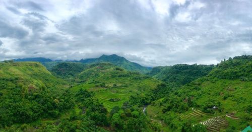 High angle view of rice field and mountains against sky