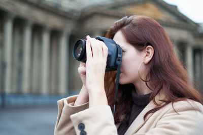 Close-up of woman photographing with camera