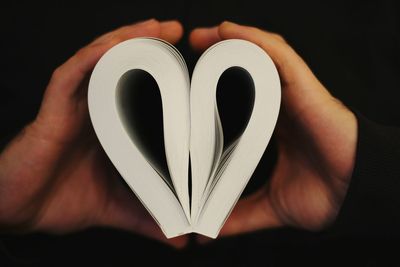 Close-up of human hand holding book