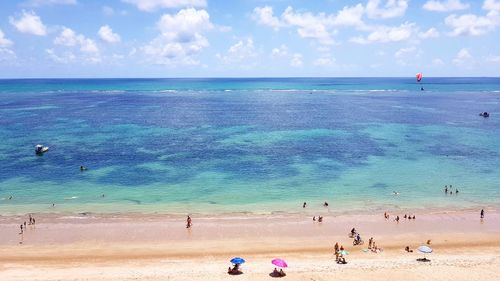 People on beach against sky