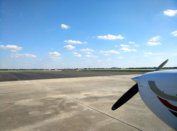 Airplane on runway against sky