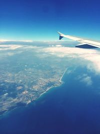 Cropped image of airplane flying over landscape