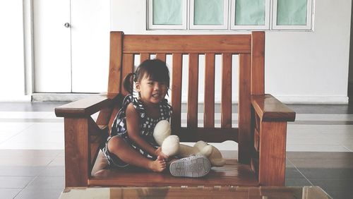 Girl sitting on seat at home