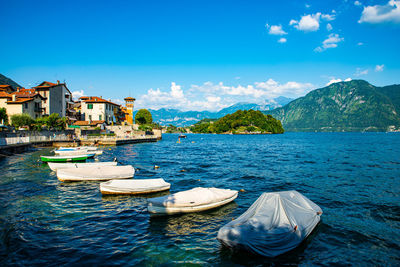 The town of sala comacina, with its boats, the marina and the lakefront, photographed in summer.