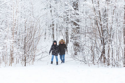 Full length of a man standing on snow covered land