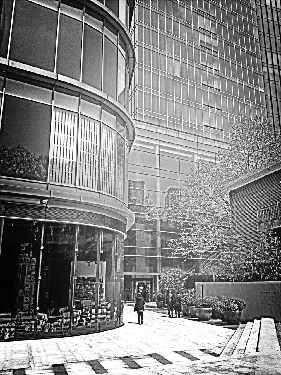 architecture, building exterior, built structure, city, building, window, street, day, sunlight, residential building, outdoors, shadow, city life, cobblestone, incidental people, facade, modern, residential structure, no people, pattern