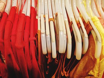 Close-up of clothes hanging on rack for sale