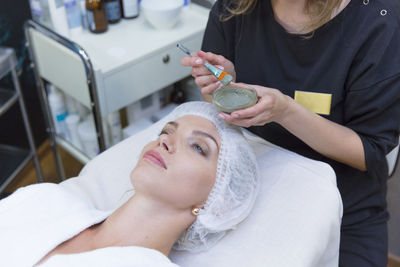 Midsection of woman lying on table