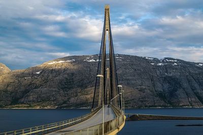 Scenic view of lake by mountain against sky