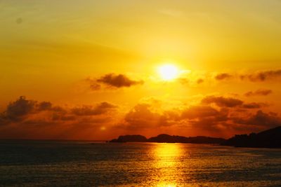 Scenic view of sea against orange sky