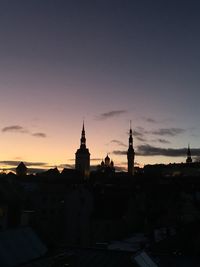 Silhouette of cityscape against sky