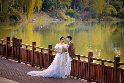 Rear view of couple standing in lake