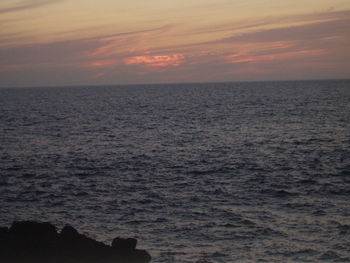 Scenic view of sea against sky at sunset