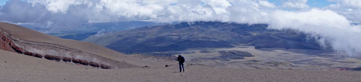 Rear view of person on snowcapped mountains against sky