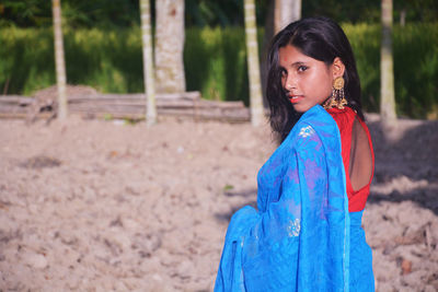 Portrait of woman standing on land