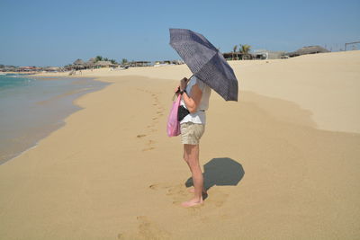 Full length of young woman walking on beach