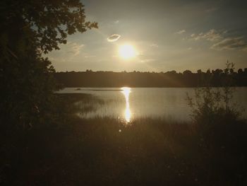 Scenic view of lake against sky during sunset