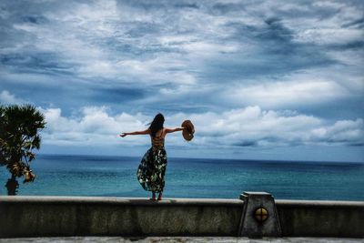 Full length of man in sea against sky