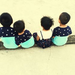 High angle view of children sitting on floor