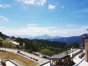 High angle view of road by trees against sky