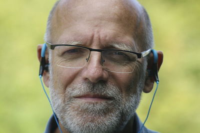 Close-up portrait of man wearing hearing aid