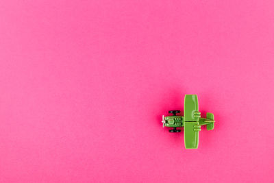 High angle view of toy against pink background