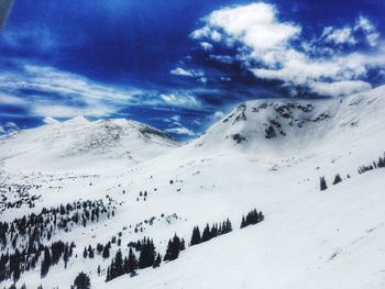 Scenic view of snow covered mountains against sky