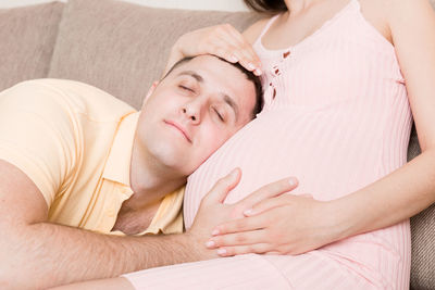 Midsection of woman lying on bed