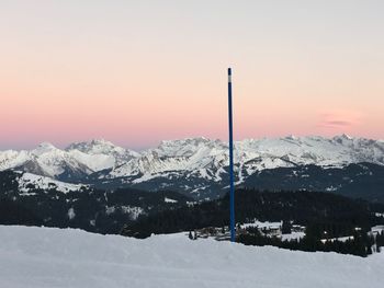 Snow covered mountains against sky during sunset