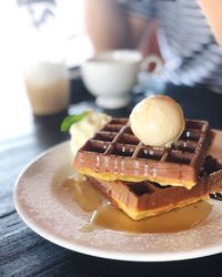 Close-up of waffles in plate on table